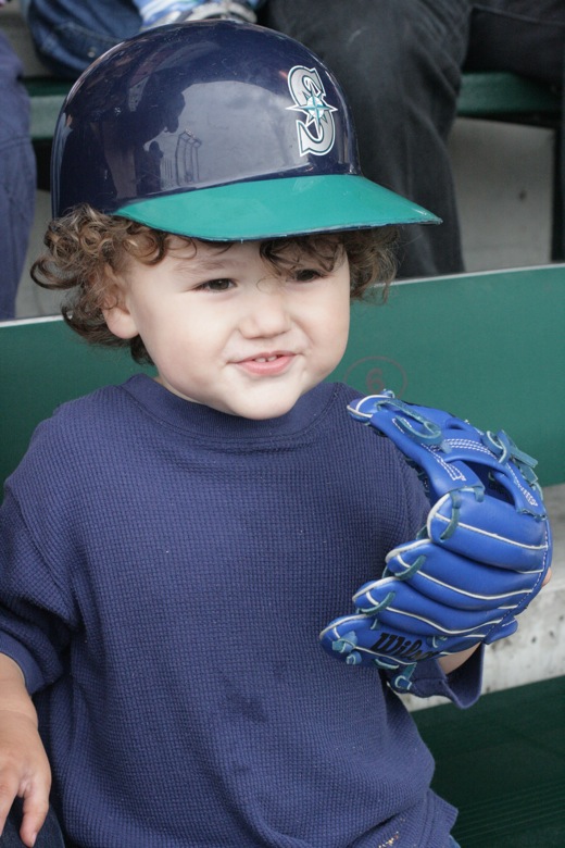 boy with seattle mariners batting helmet and baseball glove