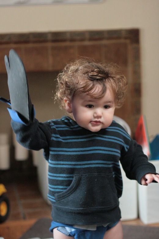 toddler with oven mitt