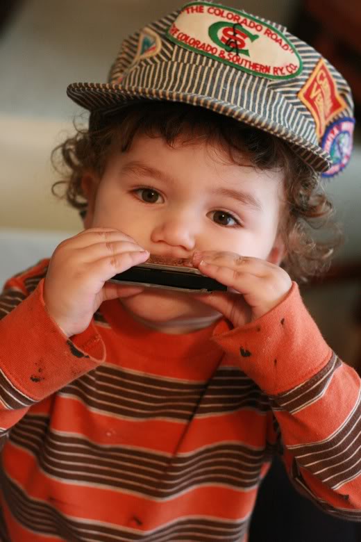 Hobo Baby with train conductor's hat and harmonica