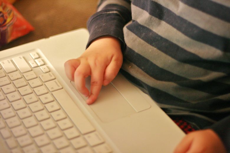 boy blogger's fingers on laptop