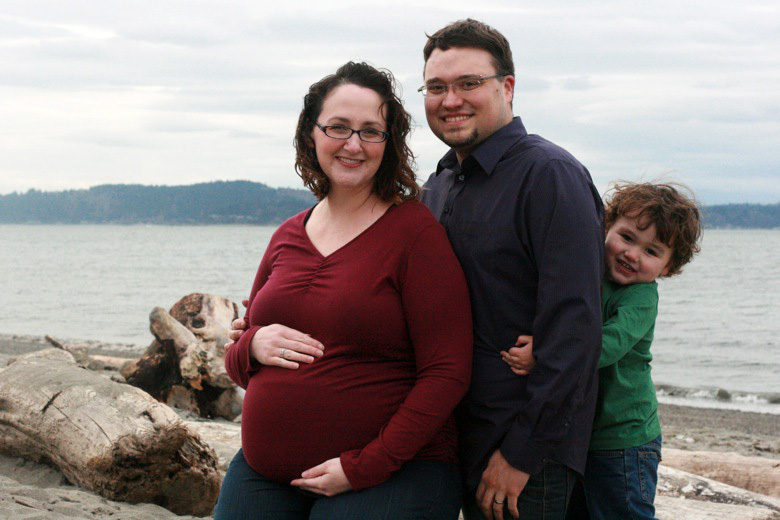sweet pregnancy peekaboo — family maternity photo shoot on the beach