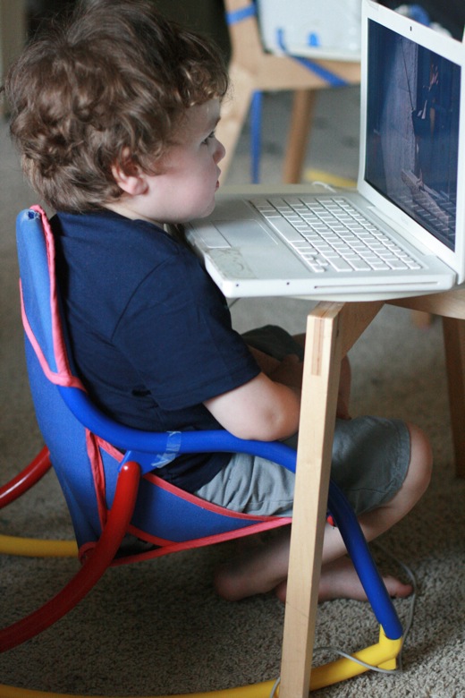 preschooler boy sits too close to the computer laptop screen — mikko 4 years old 4yo m4yo