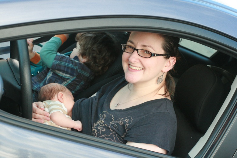 newborn baby Alrik 4 weeks breastfeeding with mama and brother in car