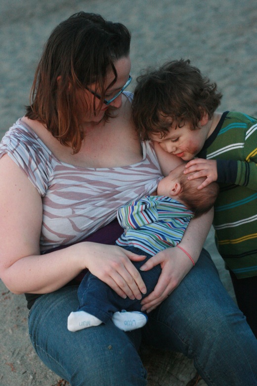 newborn baby Alrik week 5 and mikko 4 years old with mother breastfeeding on beach
