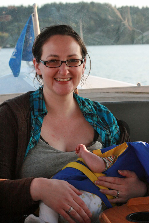 Liberty Bay boating outdoors — alrik newborn baby breastfeeding on boat in life jacket