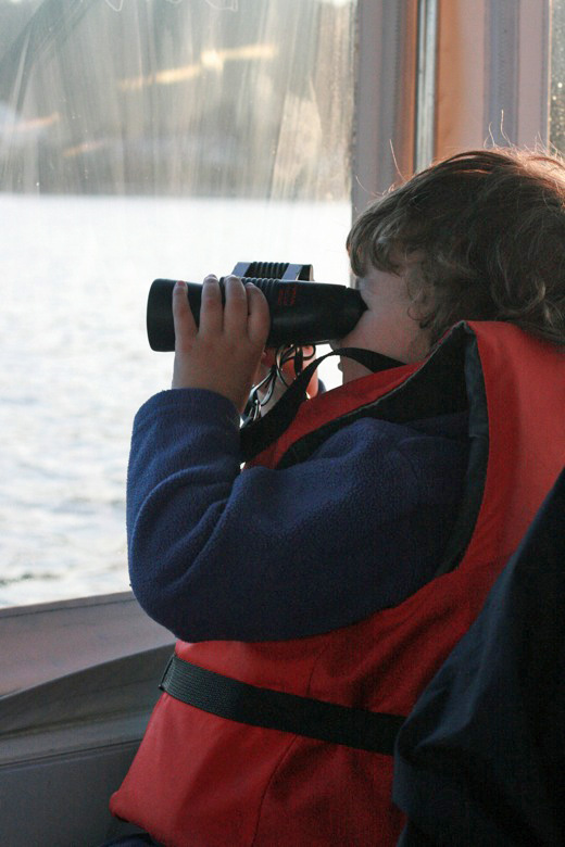 Liberty Bay boating outdoors — mikko m4yo using binoculars out window of boat