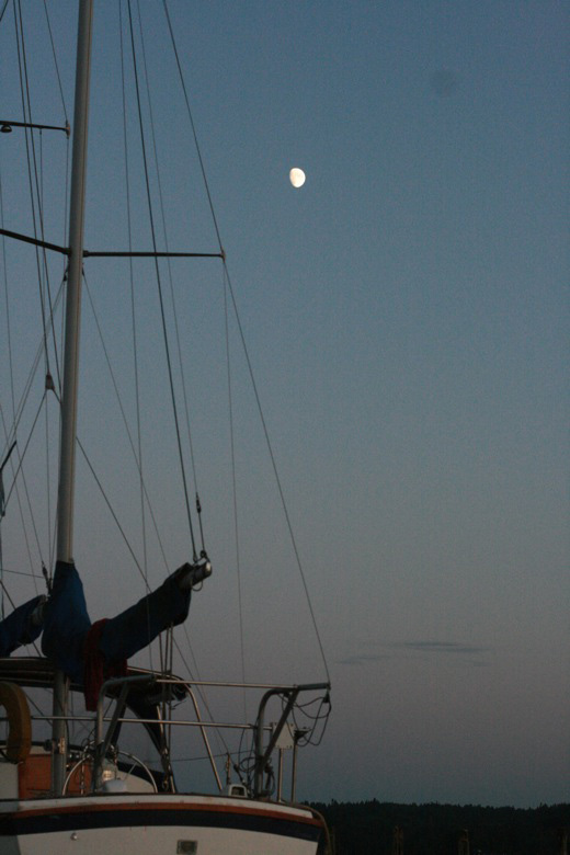 Liberty Bay boating outdoors — moonrise over a sailboat