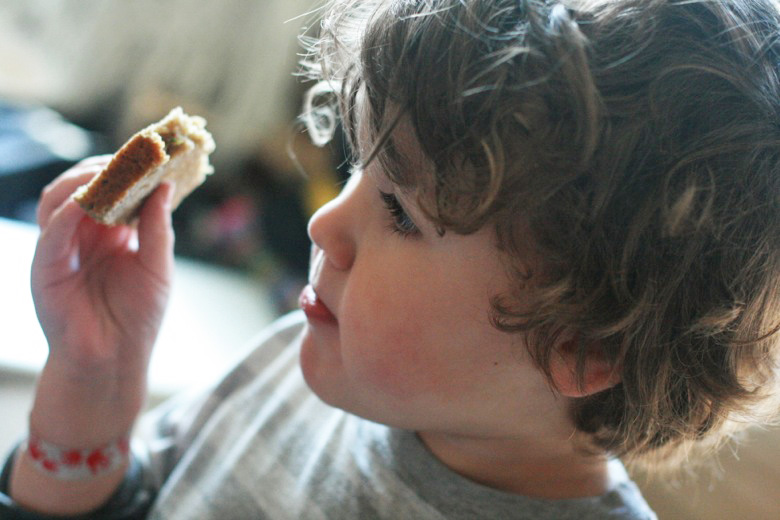 boy eating zucchini bread in sunlight