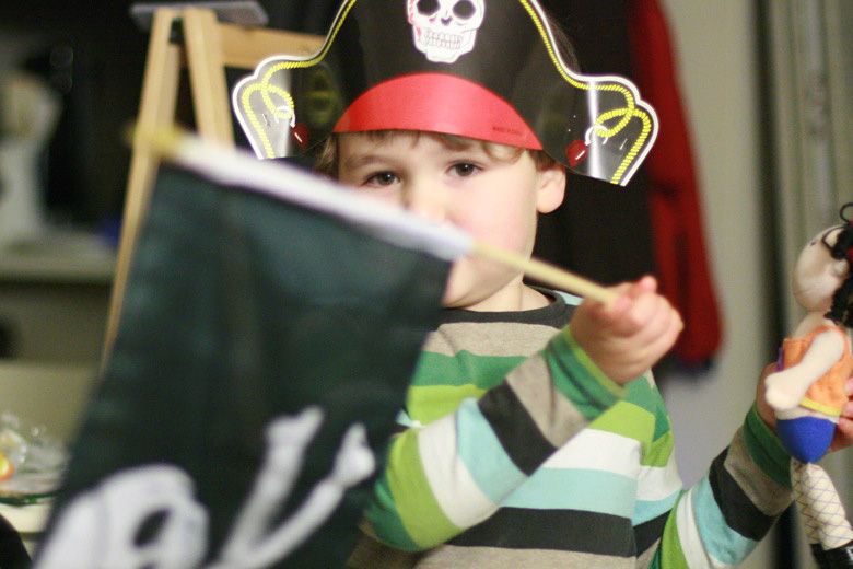 boy waving pirate flag