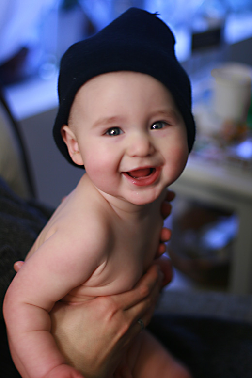 baby smiling in winter hat — alrik a7mo