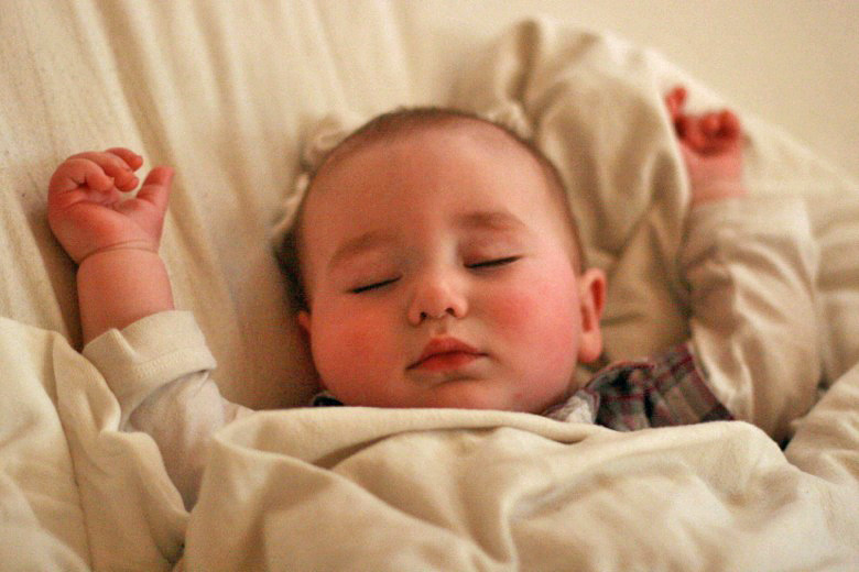 baby sleeping with arms up — cosleeping