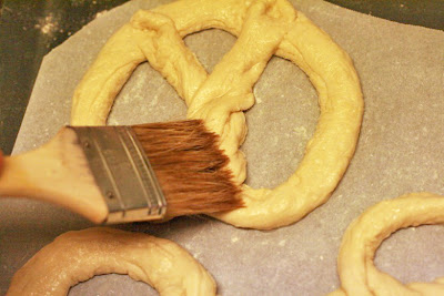 brushing on wash - cooking homemade soft pretzels