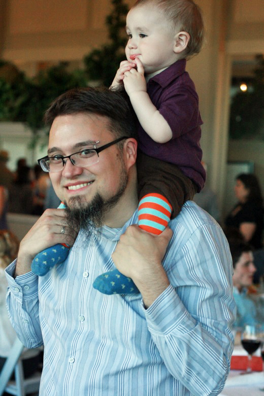dad and baby on shoulders at wedding