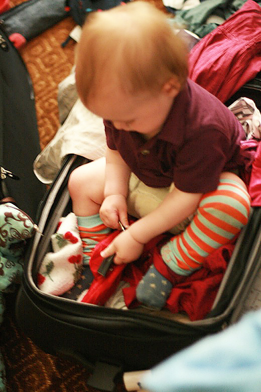 baby helping unpack a suitcase &#8212; california road trip travel alrik a1yo a13mo