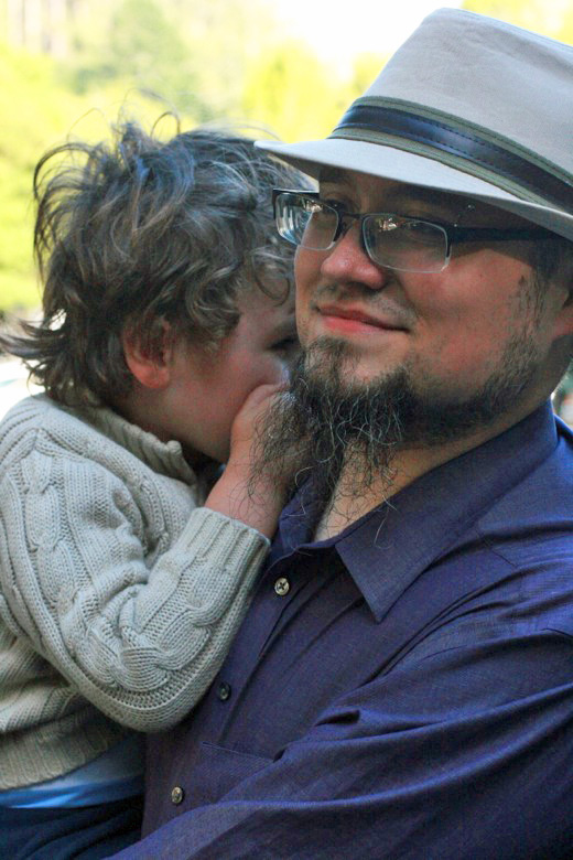 boy snuggling with dad in Muir Woods