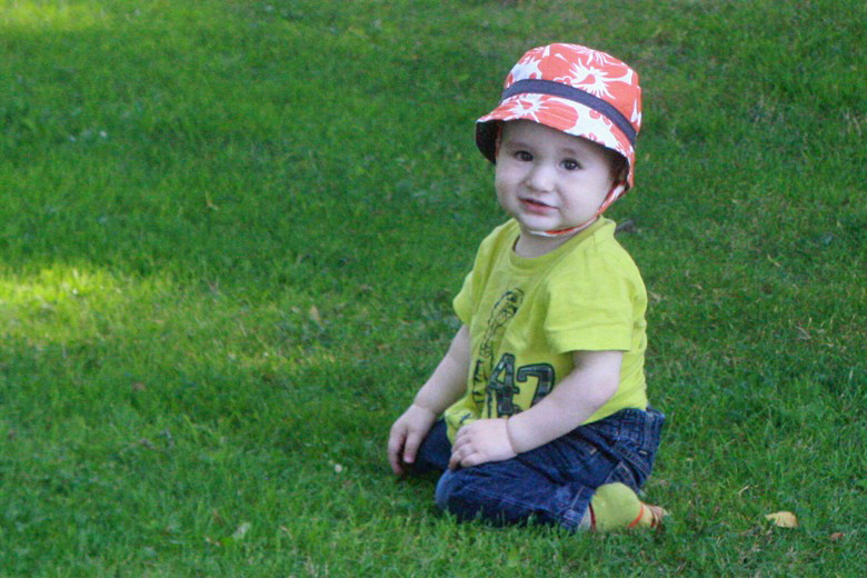 toddler boy sitting on grass