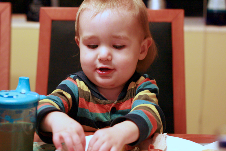 baby reaching for food on brother's plate &#8212; Thanksgiving dinner 2012 holidays