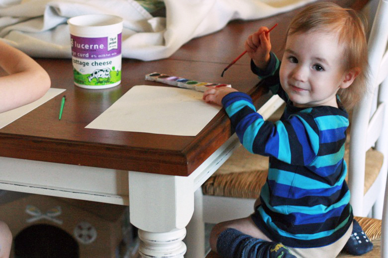 toddler painting with watercolors at table - crafts art