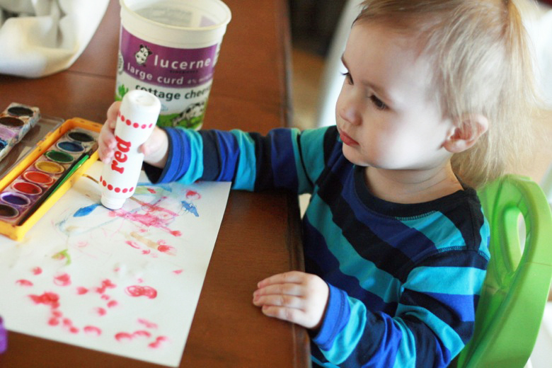 toddler painting with dot paint sticks at table - crafts art