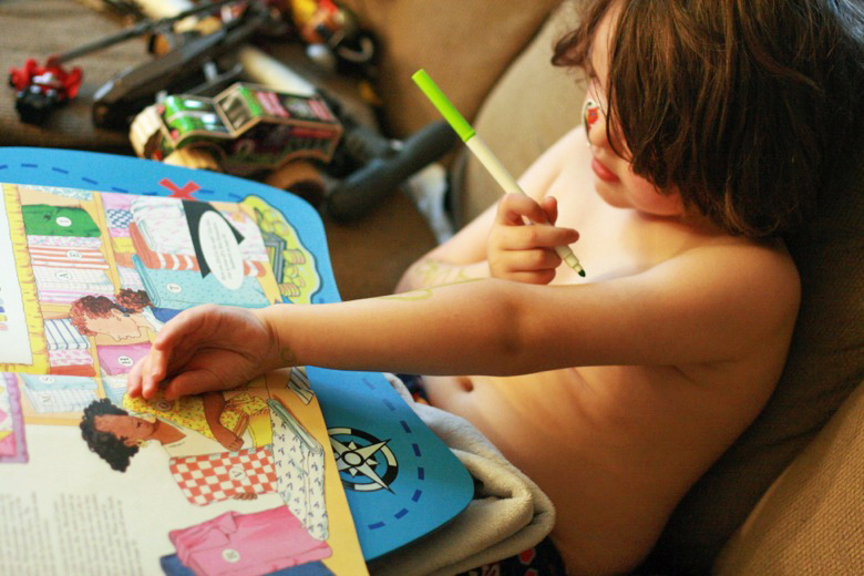 boy drawing crib sheet on arms with marker - crafts art