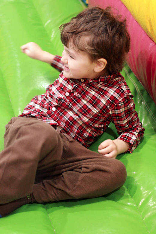 boy enjoying bouncy house at carnival at toddler play gym community center - Easter 2013 holidays
