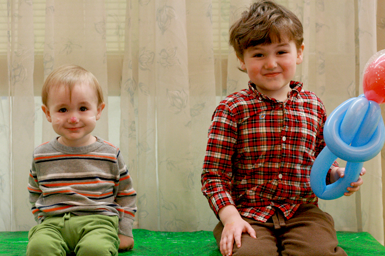 siblings on bench at carnival at toddler play gym community center - Easter 2013 holidays