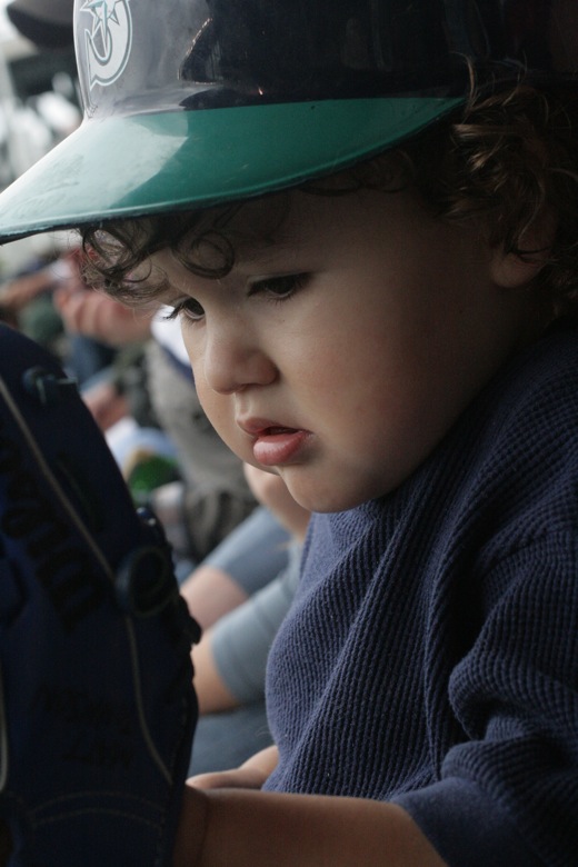 boy with baseball batter helmet at seattle mariners game