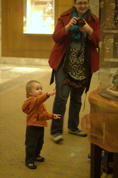 baby pointing at gingerbread house display case — Christmas downtown Seattle meetup holidays