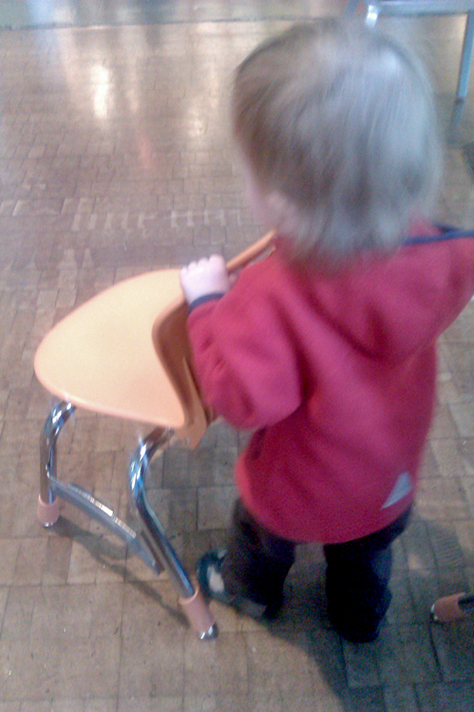 pushing a chair around the armory - pacific science center outing seattle unschooling