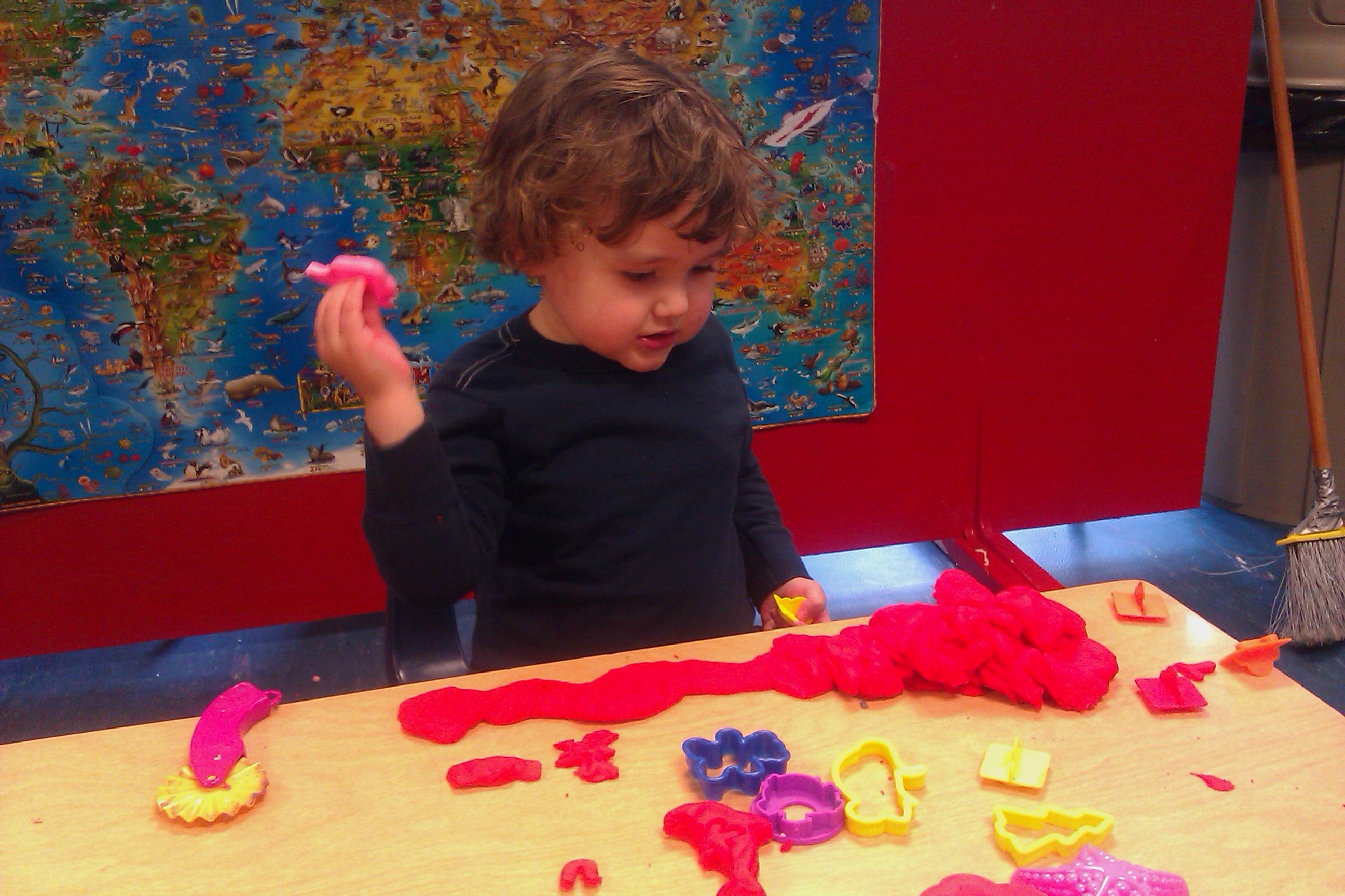 boy at preschool playing with play-doh