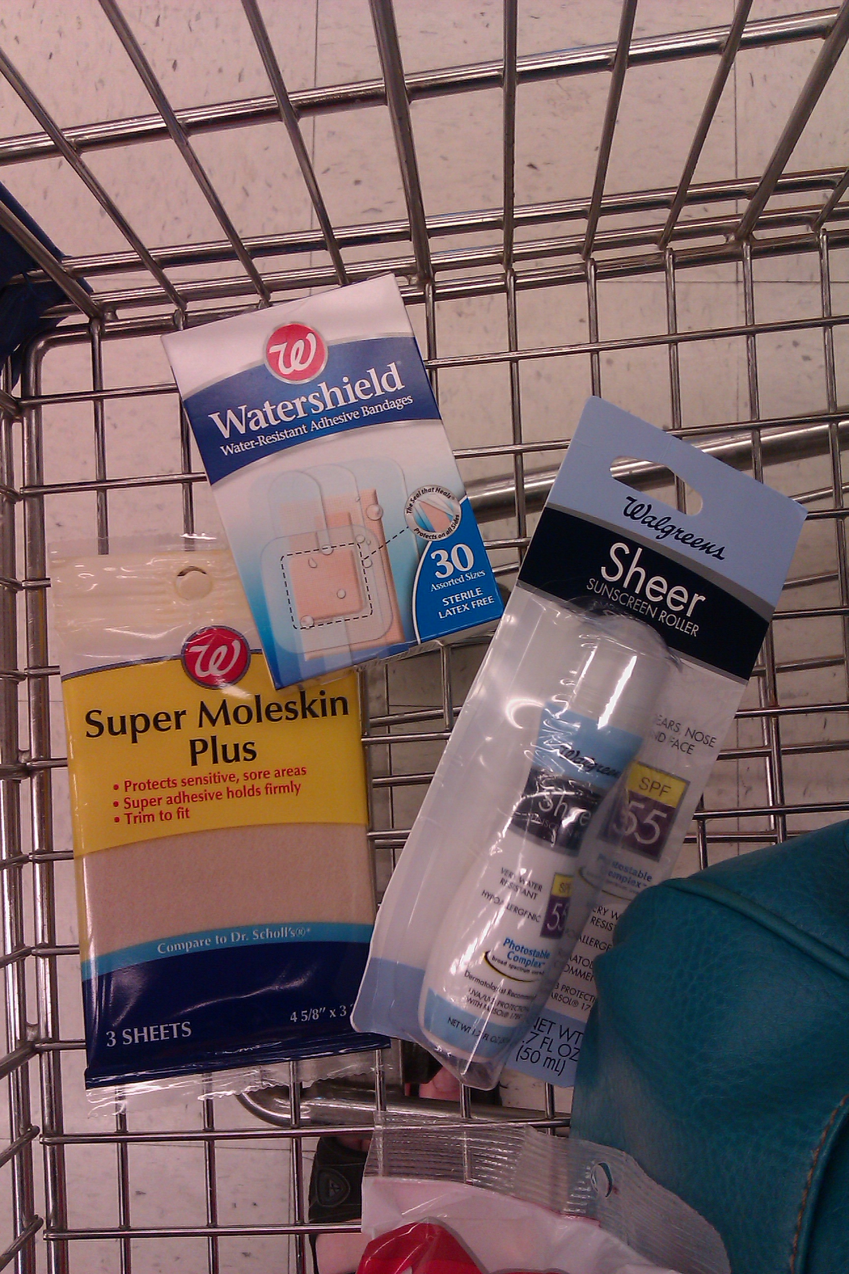 three Walgreens items in cart: sunscreen face roll-on, Super Moleskin Plus, Watershield bandages variety pack