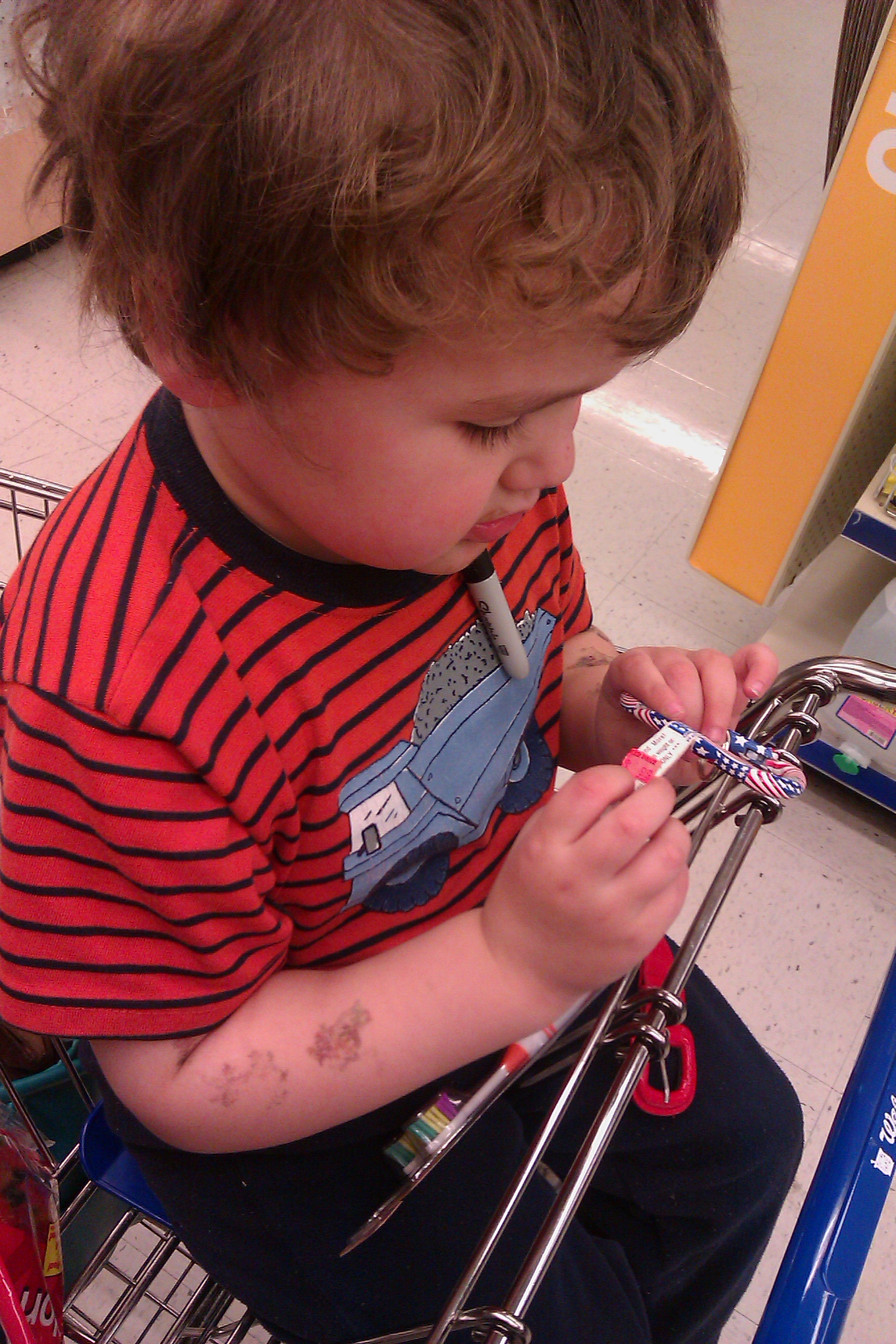 boy at Walgreens with clearance bin flag keychain carabiner