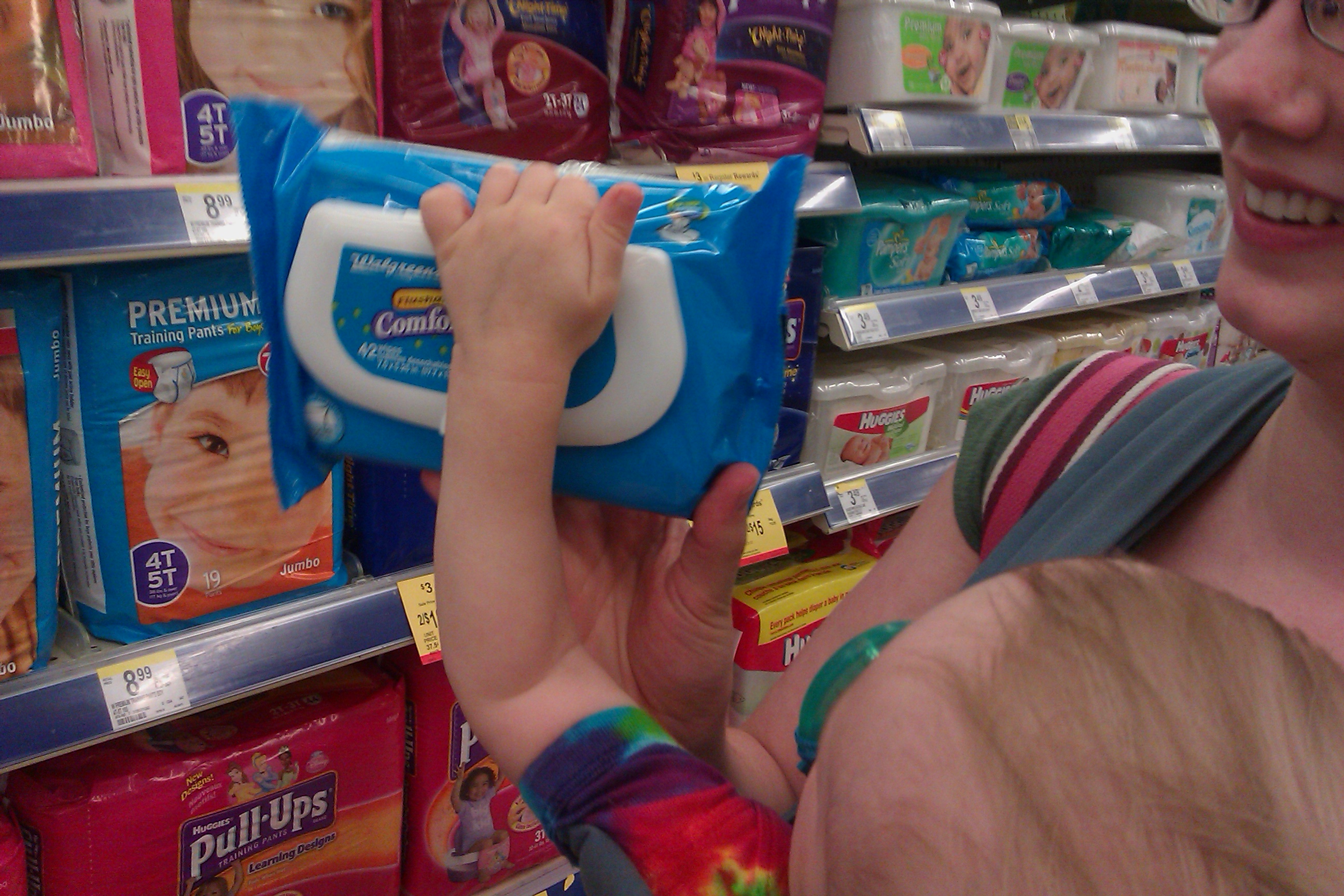 picking out flushable wipes with baby at Walgreens