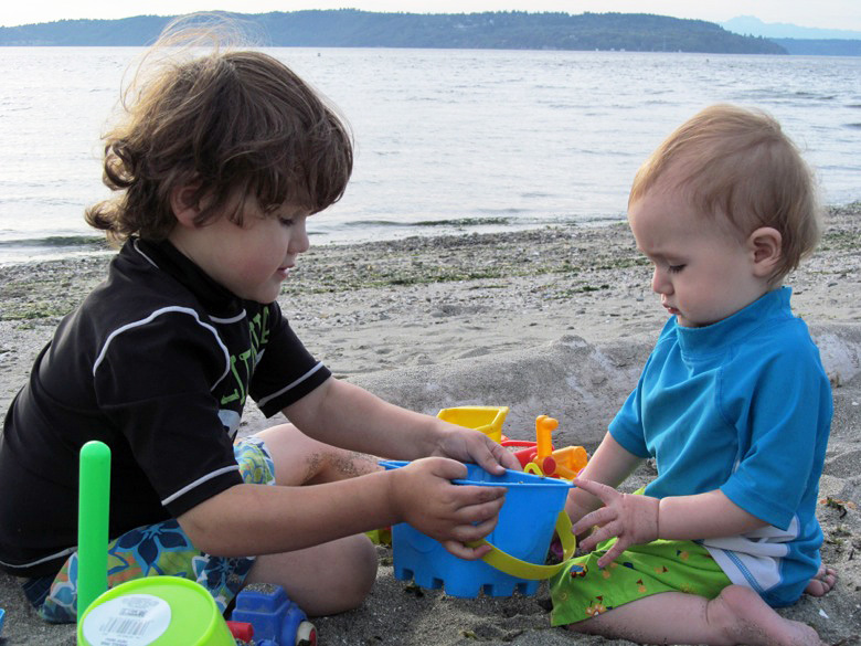 brothers playing on beach at family camping