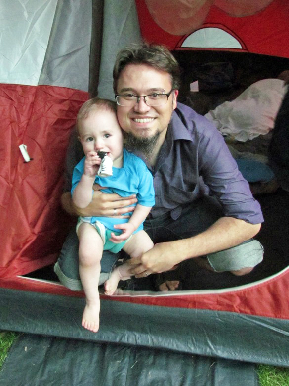 dad and boy in tent while camping