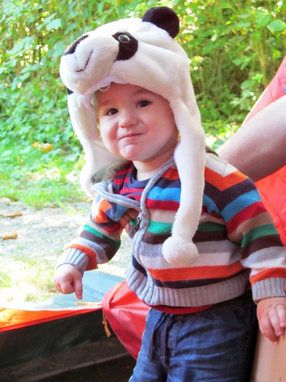 baby in panda hat in tent in family camping