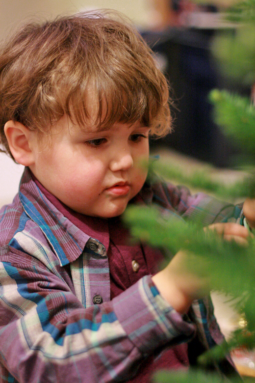 boy decorating Christmas tree in Fuerte polo shirt and Fiesta plaid shirt — Tea Collection giveaway