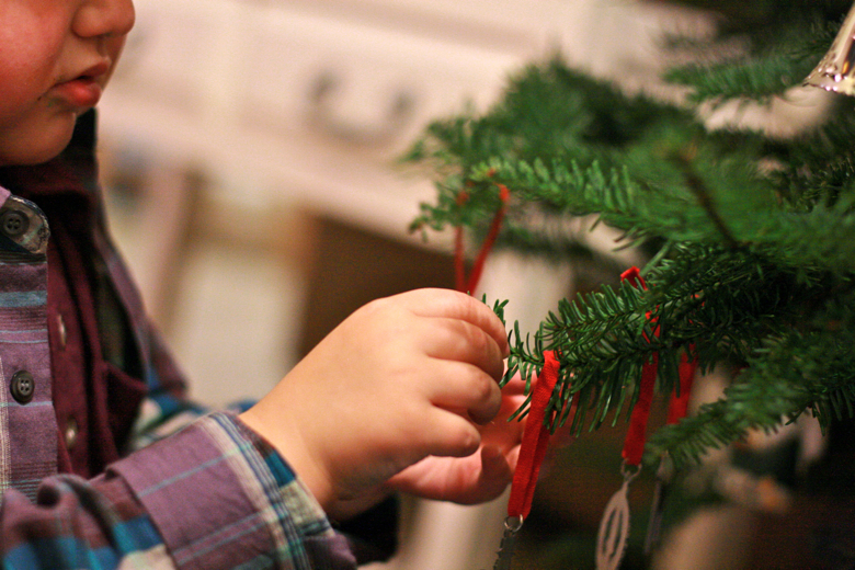boy adding ornament on tree &#8212; Christmas 2011