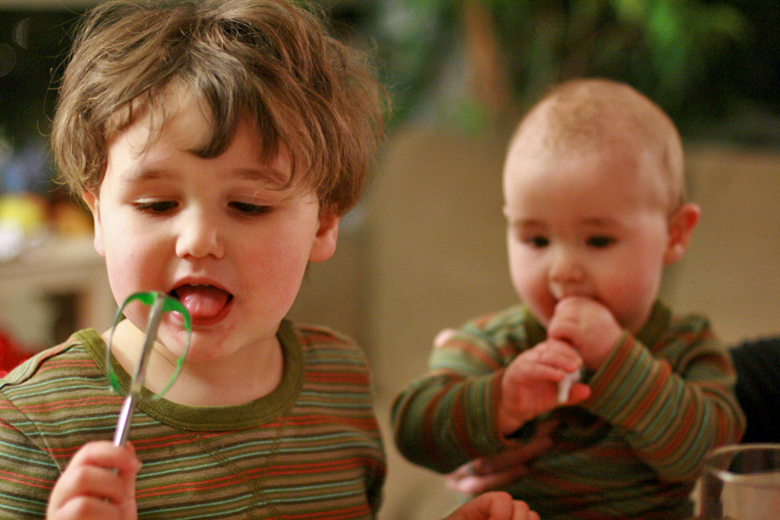 baby and boy licking cookie decorations in Diego striped shirts — Tea Collection giveaway