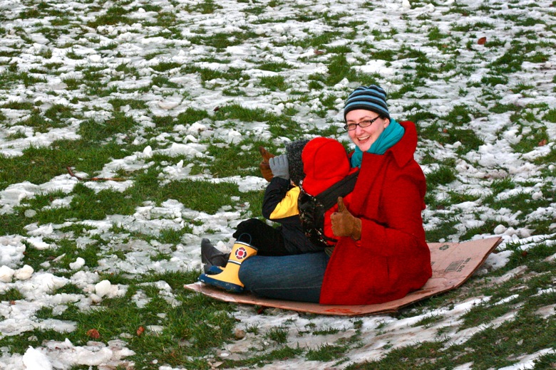 mom and kids sledding in winter outdoors in Seattle