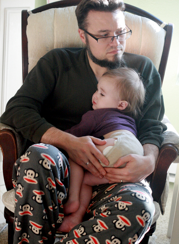 sick toddler snuggling with dad