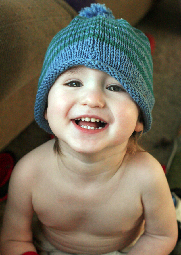 toddler boy in knit stripe hat smiling cute happy