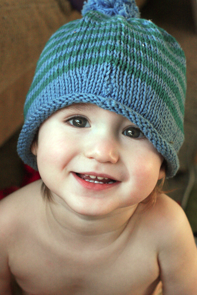 smiling cute toddler in knit hat