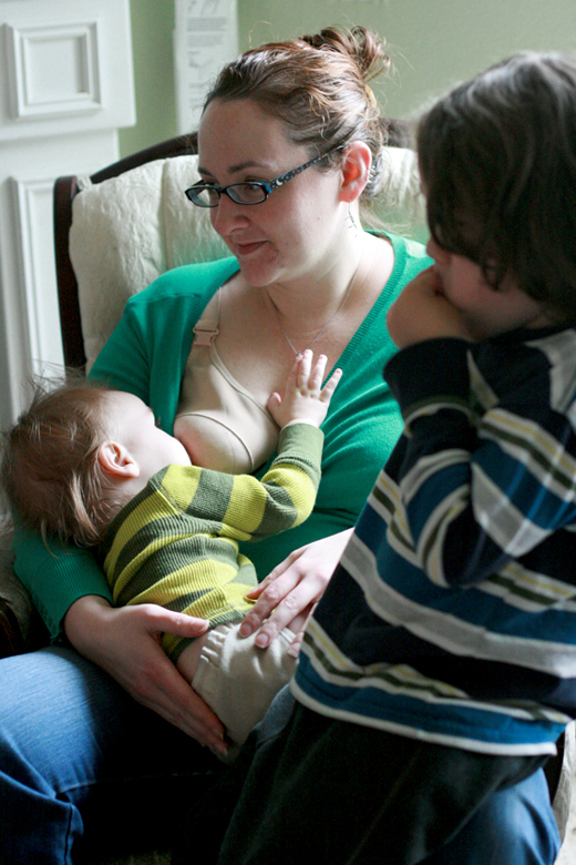nursing baby grabbing necklace with mom and brother - valentine's day 2013