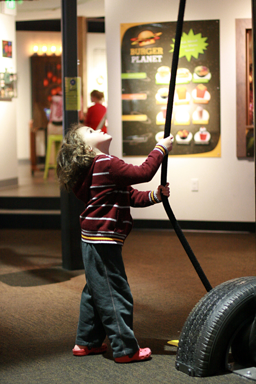 boy tugging rope pulley - pacific science center outing seattle unschooling