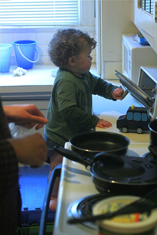 toddler checking the toaster oven