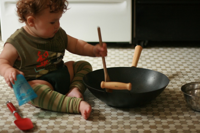 baby stirring flour and water in a wok
