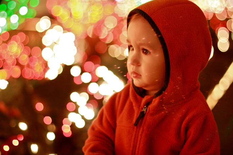 baby looking at Menashe Christmas lights