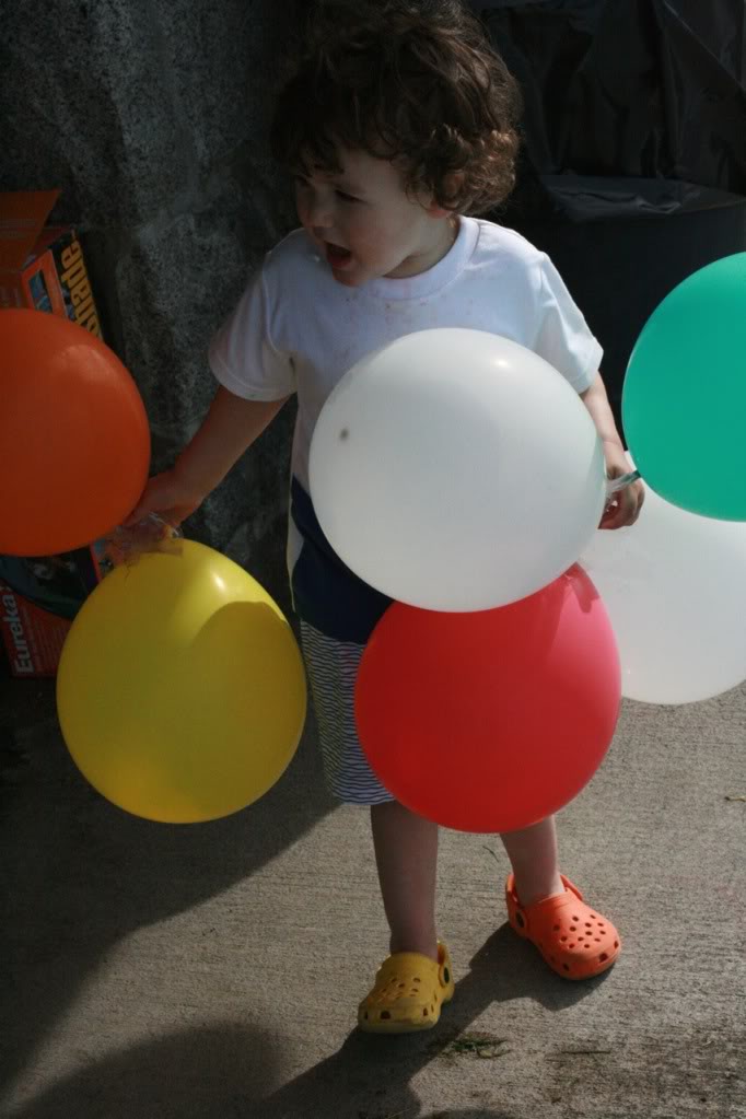 toddler with balloons