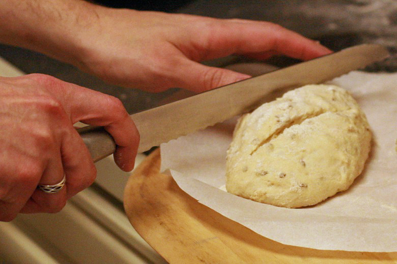 slicing slits in dough loaves with serrated knife - cooking homemade easy bread recipe